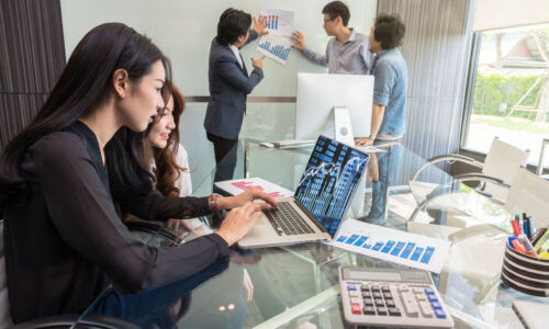 Group Of Asian Business people with casual suit using the technology laptop about Stock market exchange data information and talking together in the modern Office, people business group concept